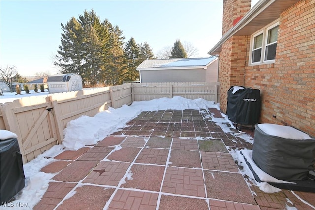 snow covered patio featuring area for grilling