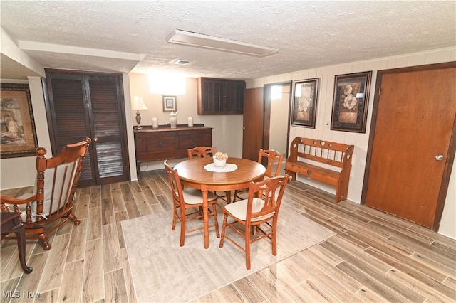 dining area featuring a textured ceiling