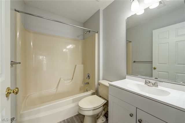 full bathroom featuring shower / bath combination, hardwood / wood-style floors, vanity, a textured ceiling, and toilet