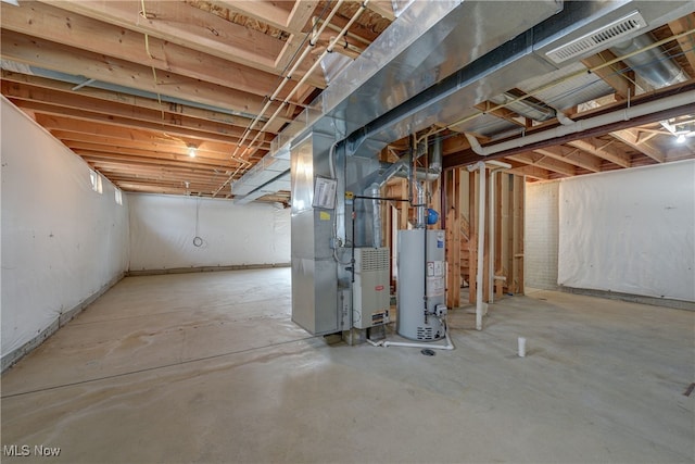 basement with gas water heater and heating unit