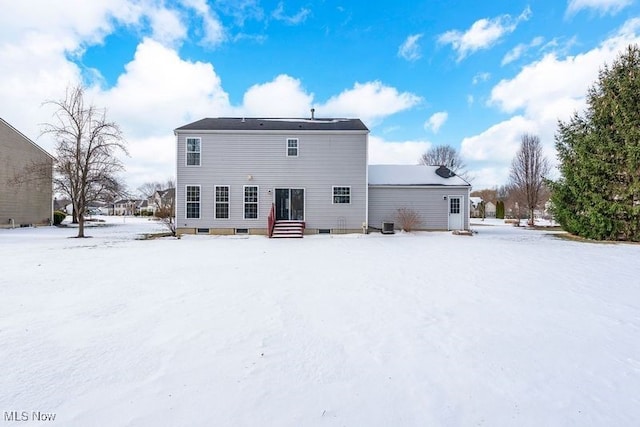 view of snow covered rear of property