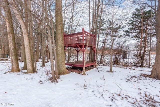 snowy yard with a wooden deck