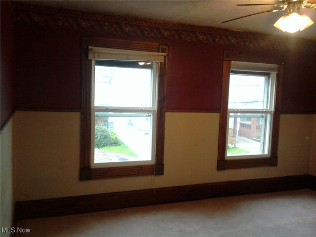 bonus room with light colored carpet and ceiling fan