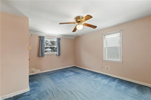 empty room featuring ceiling fan and carpet flooring