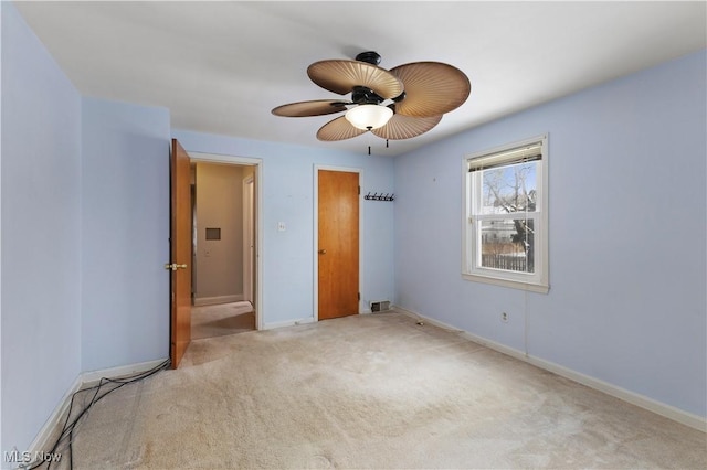 unfurnished bedroom featuring ceiling fan and light colored carpet