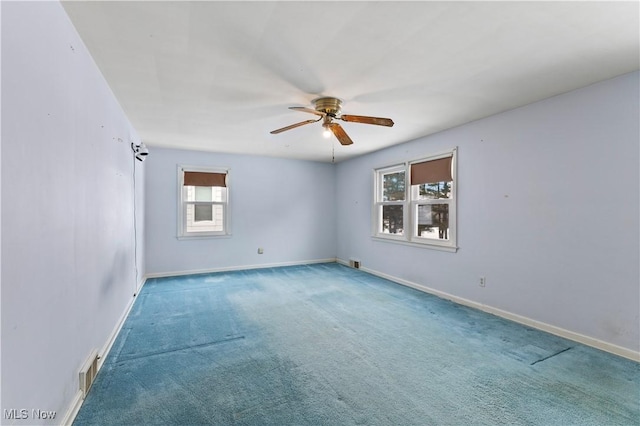 carpeted spare room with ceiling fan