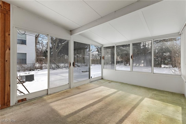 unfurnished sunroom featuring a healthy amount of sunlight and vaulted ceiling with beams