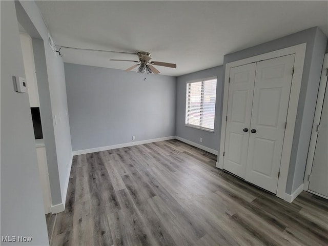 unfurnished bedroom with ceiling fan, light hardwood / wood-style floors, and a closet