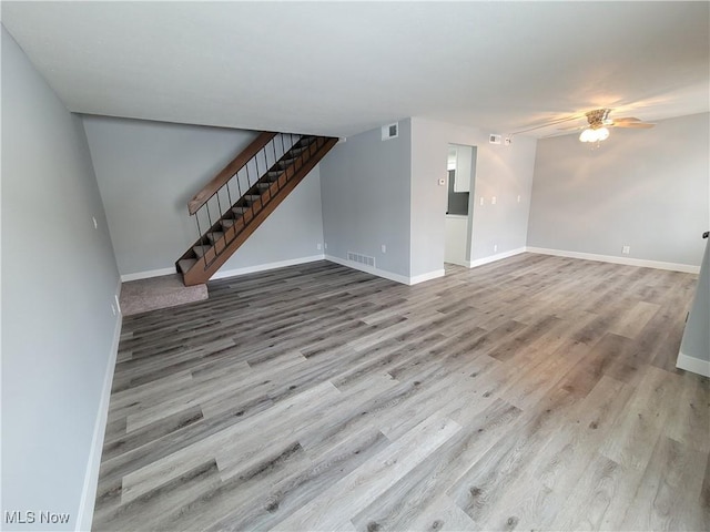 unfurnished living room featuring light hardwood / wood-style flooring and ceiling fan