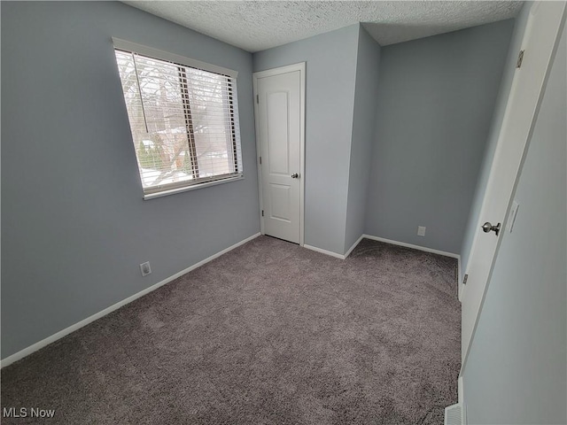 unfurnished bedroom featuring light carpet and a textured ceiling