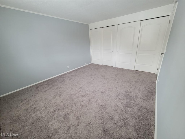 unfurnished bedroom featuring carpet floors and ornamental molding