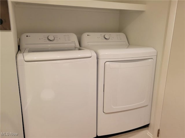 clothes washing area with washing machine and dryer