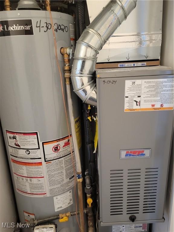 utility room featuring gas water heater