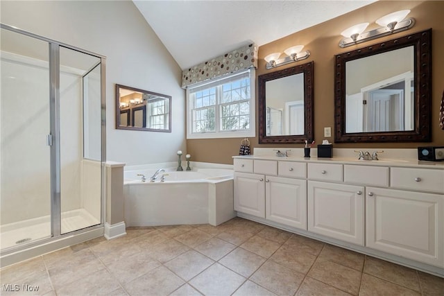 bathroom with vanity, vaulted ceiling, tile patterned floors, and shower with separate bathtub