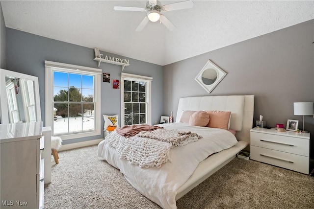 carpeted bedroom featuring ceiling fan and a textured ceiling