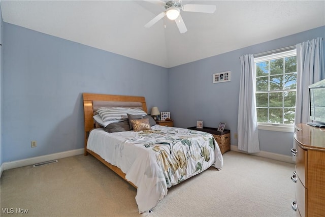 bedroom featuring vaulted ceiling, light colored carpet, and ceiling fan