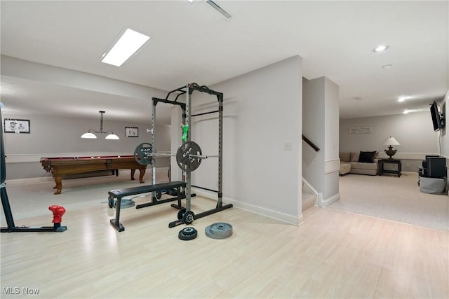 exercise room with pool table and light hardwood / wood-style flooring