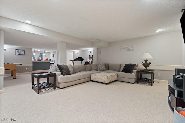 living room with a textured ceiling and carpet