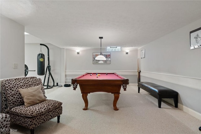 game room with light carpet, pool table, and a textured ceiling