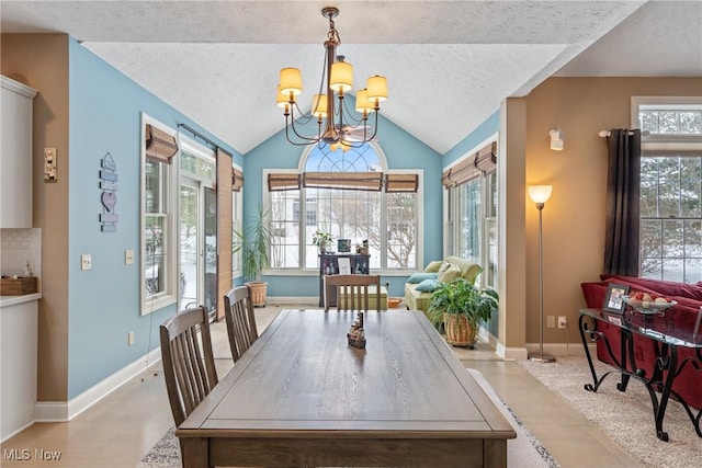 dining space featuring vaulted ceiling, a notable chandelier, and a textured ceiling