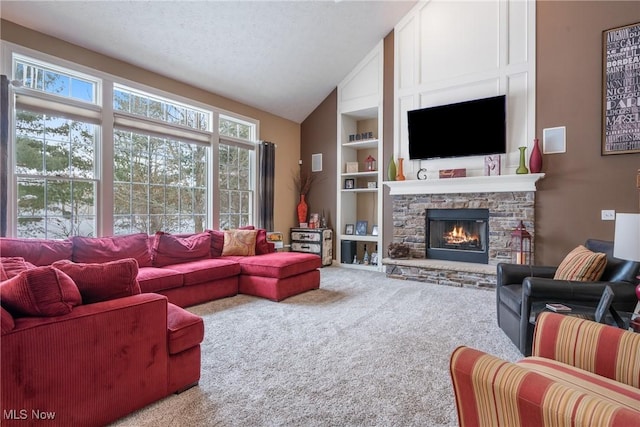 living room with vaulted ceiling, built in features, a fireplace, carpet floors, and a textured ceiling