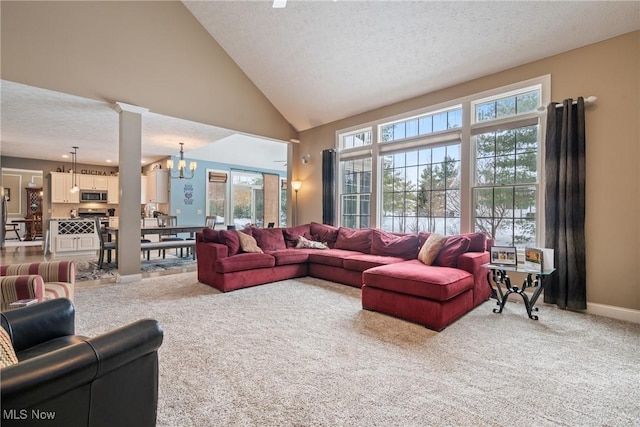 carpeted living room featuring ornate columns, high vaulted ceiling, a notable chandelier, and a textured ceiling