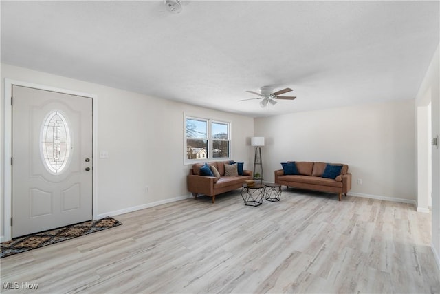 living room featuring ceiling fan and light wood-type flooring