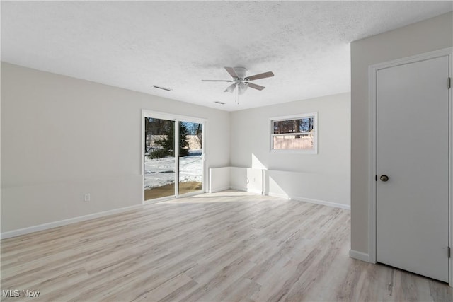 spare room featuring ceiling fan, a textured ceiling, and light hardwood / wood-style floors