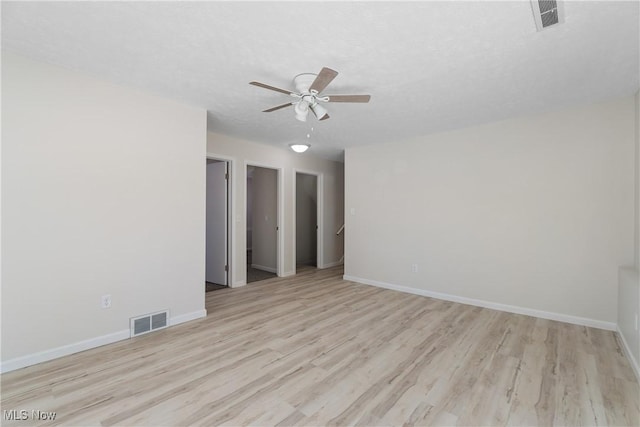 unfurnished room featuring ceiling fan, a textured ceiling, and light wood-type flooring