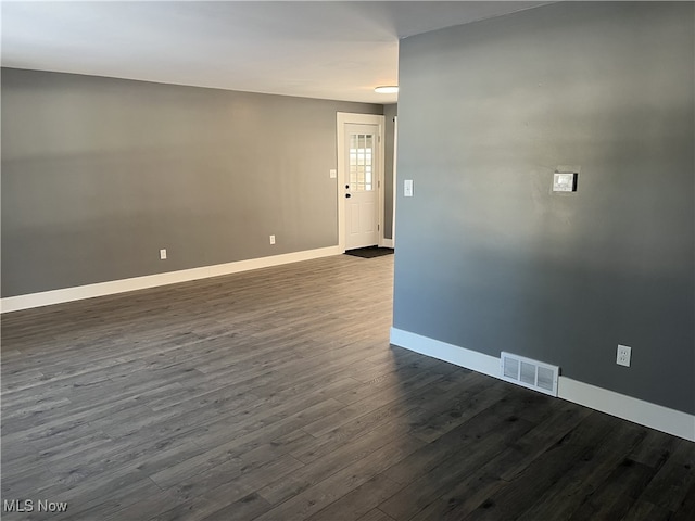 unfurnished room featuring dark hardwood / wood-style flooring