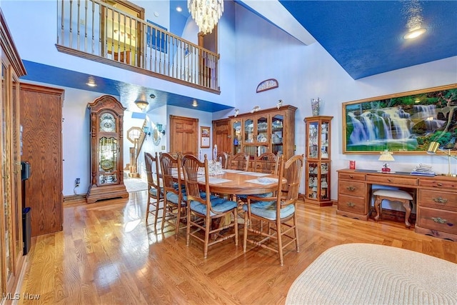 dining space featuring a chandelier and light hardwood / wood-style flooring