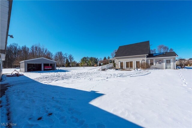 yard layered in snow featuring a garage