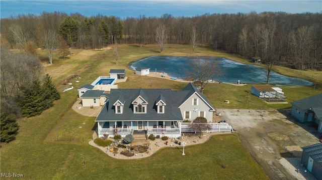 bird's eye view with a water view and a wooded view