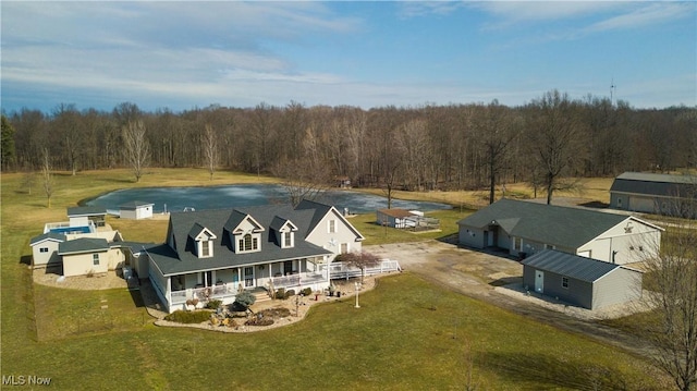 bird's eye view with a wooded view