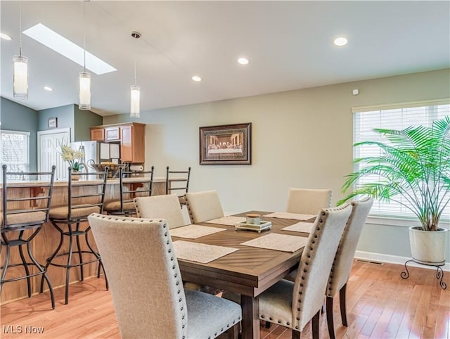 dining space featuring light wood-type flooring