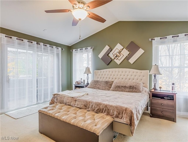 bedroom with ceiling fan, lofted ceiling, and carpet floors