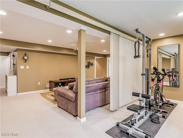 exercise area with light colored carpet and ceiling fan