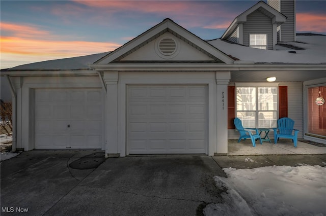 view of garage at dusk