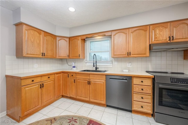 kitchen featuring stainless steel appliances, tasteful backsplash, sink, and a textured ceiling