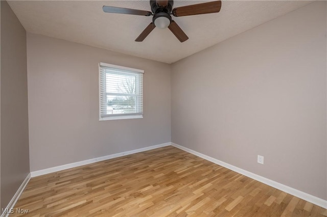 spare room with light hardwood / wood-style flooring and ceiling fan