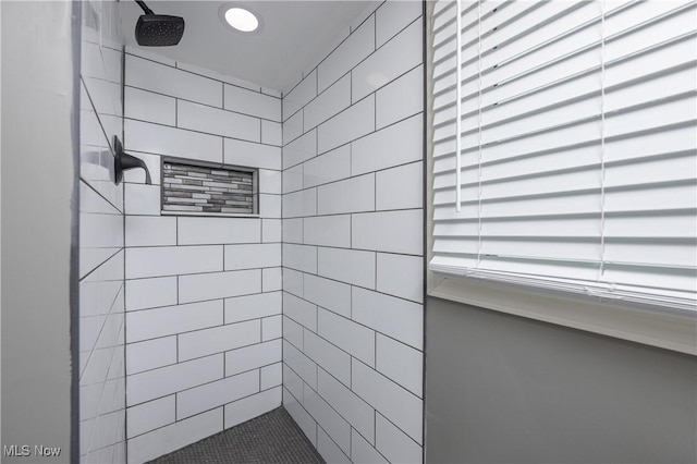 bathroom with tiled shower