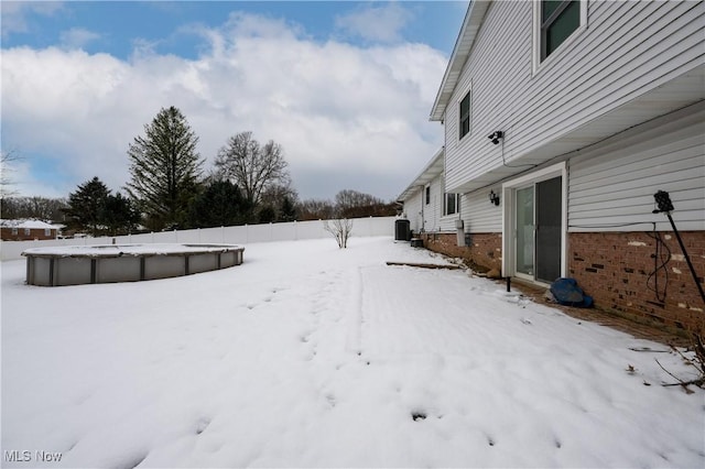 yard covered in snow with central AC unit