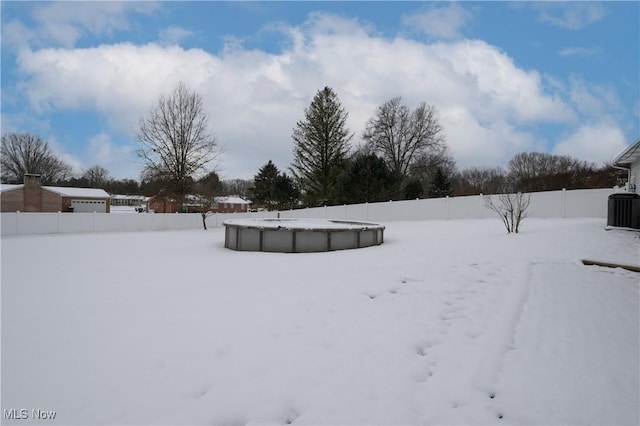 snowy yard featuring central AC unit