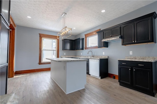 kitchen featuring a center island, hanging light fixtures, a textured ceiling, plenty of natural light, and white dishwasher