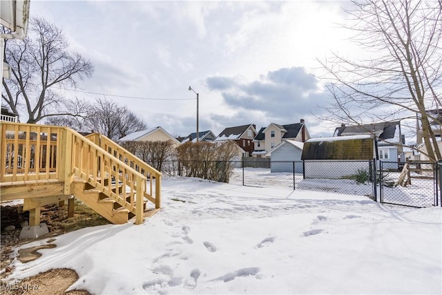 yard covered in snow with a wooden deck