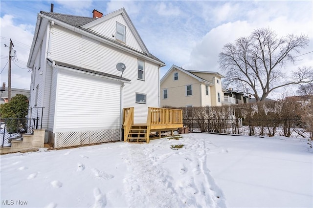 snow covered property featuring a deck