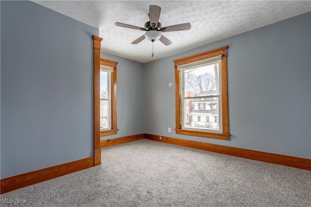 spare room with ceiling fan, carpet, and a textured ceiling