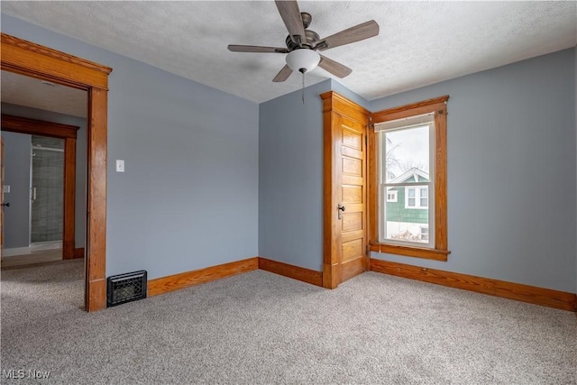 spare room featuring ceiling fan, a textured ceiling, and carpet flooring