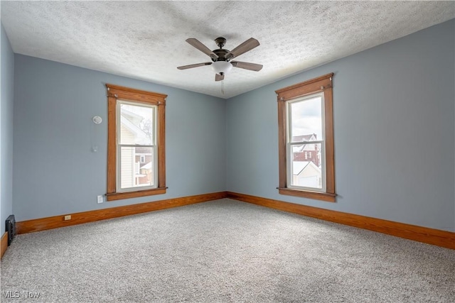 unfurnished room with ceiling fan, carpet floors, and a textured ceiling