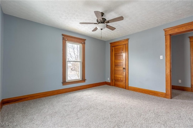 unfurnished bedroom featuring carpet flooring, a textured ceiling, and ceiling fan